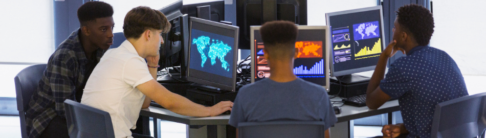 Image of young men in front of computer screens